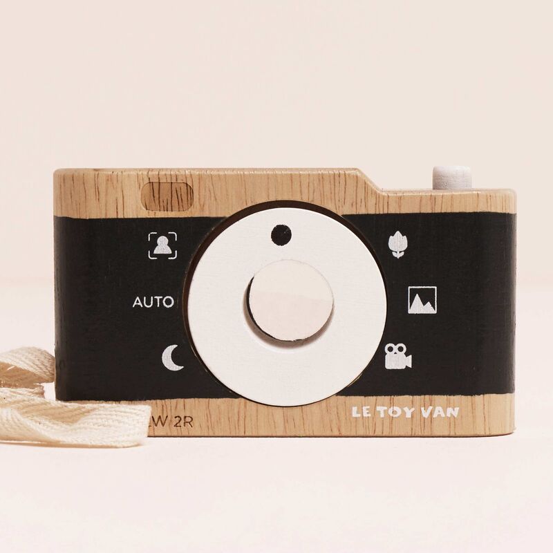 Wooden toy camera with black and white design on a beige background, brand 'Le Toy Van' visible