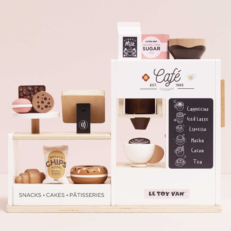 Le Toy Van coffee set with various items on a pink background