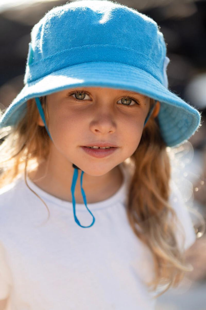 
                      
                        Terry Towelling Bucket Hat | Azure
                      
                    