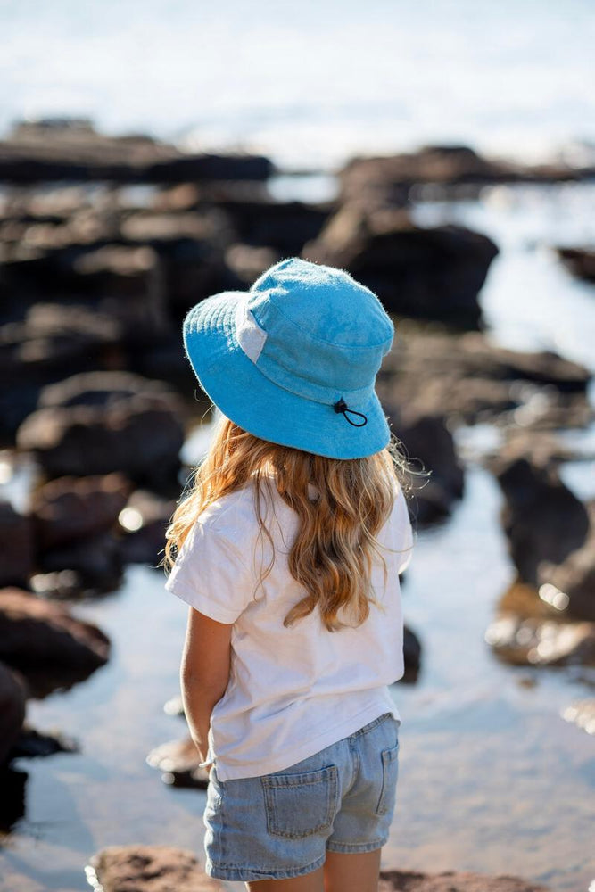 
                      
                        Terry Towelling Bucket Hat | Azure
                      
                    