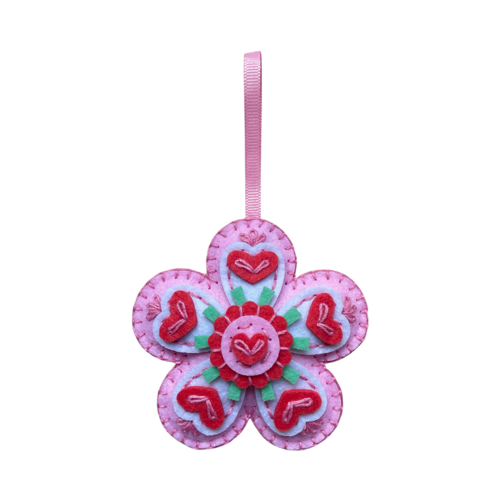 Decorative flower ornament with heart details on a white background