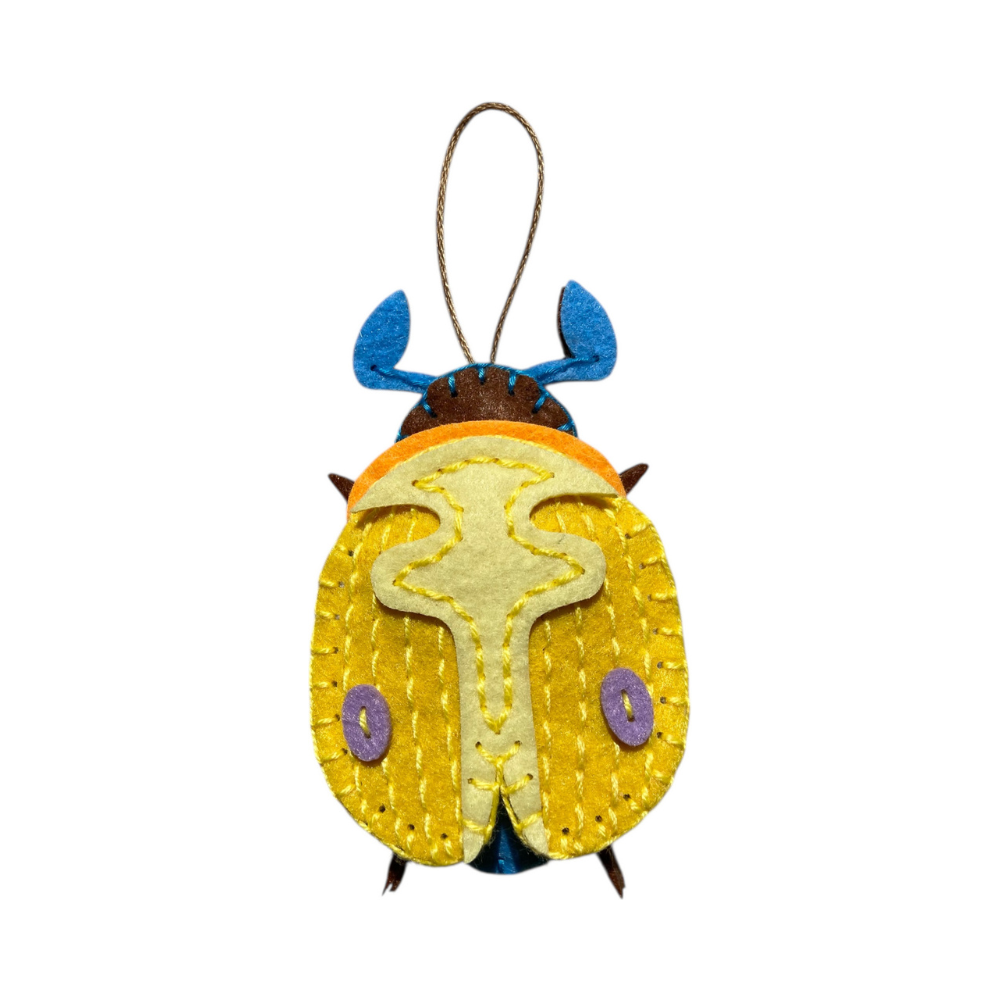 Felt ladybug ornament with a string on a white background