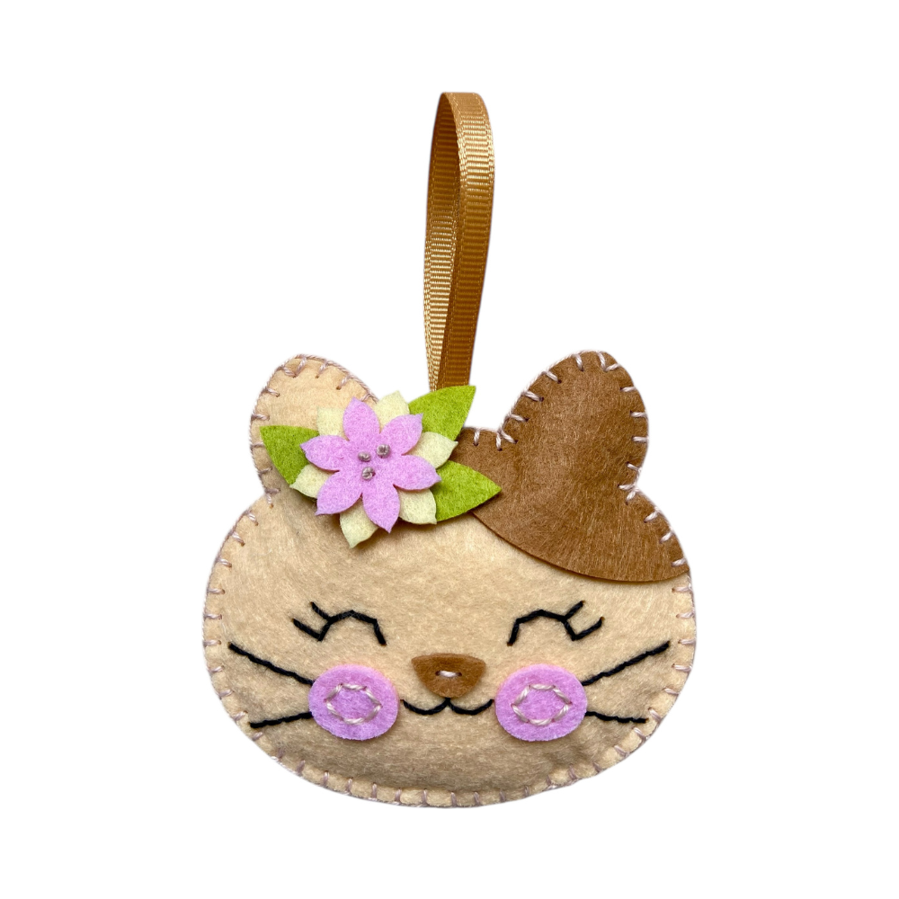 Felt cat-shaped ornament with a flower on a white background