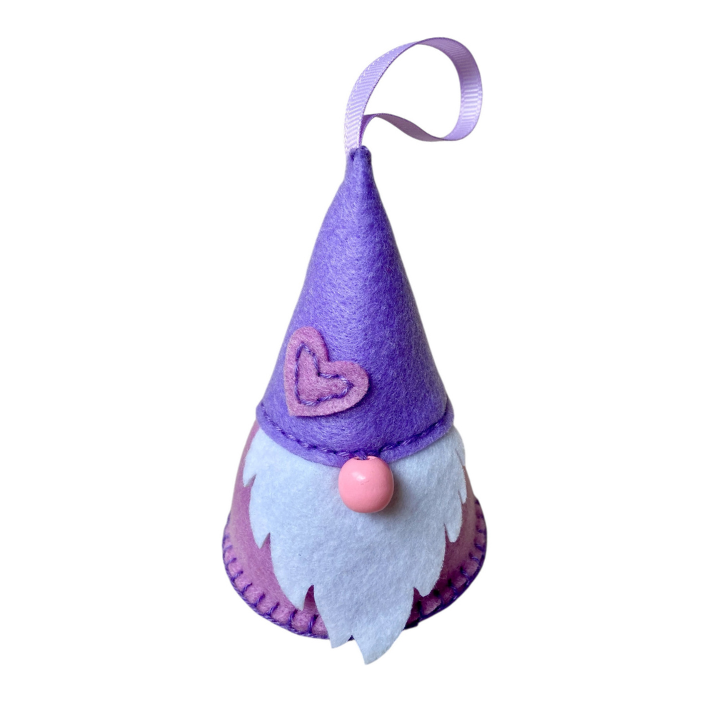 Purple gnome ornament with a pink heart and pink nose on a white background