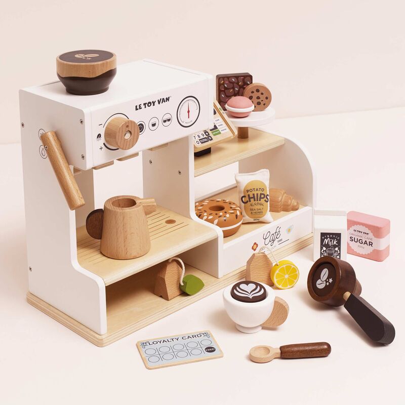 Wooden toy cafe set with various items on a white background